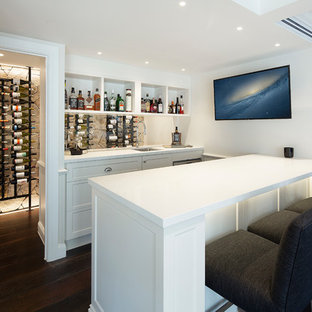 Design ideas for a mid-sized beach style seated home bar in Brisbane with an undermount sink, white cabinets, quartz benchtops, dark hardwood floors, brown floor, white benchtop, open cabinets and glass sheet splashback.