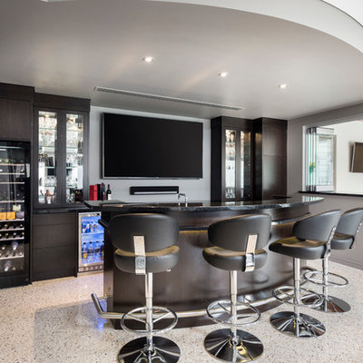 Large minimalist galley concrete floor seated home bar photo in Perth with furniture-like cabinets, dark wood cabinets and granite countertops
