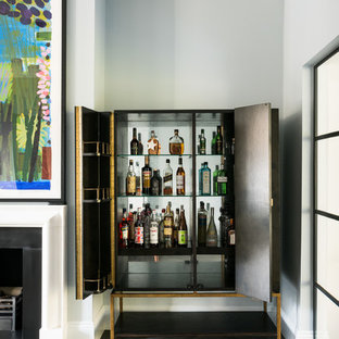This is an example of a small contemporary bar cart in London with brown floors, flat-panel cabinets, black cabinets and medium hardwood flooring.