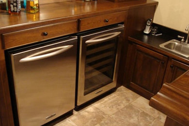 Home bar - traditional u-shaped home bar idea in Minneapolis with wood countertops and wood backsplash