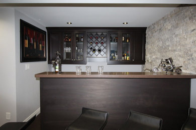Inspiration for a small contemporary single-wall wet bar remodel in Toronto with a drop-in sink, flat-panel cabinets, brown cabinets and quartz countertops