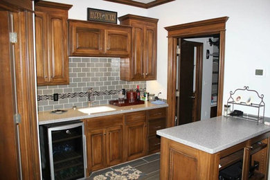 Elegant kitchen photo in Oklahoma City with medium tone wood cabinets, gray backsplash and subway tile backsplash