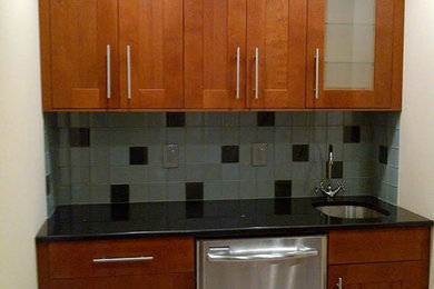 Small trendy single-wall beige floor wet bar photo in Baltimore with an undermount sink, recessed-panel cabinets, medium tone wood cabinets, quartz countertops, blue backsplash and ceramic backsplash