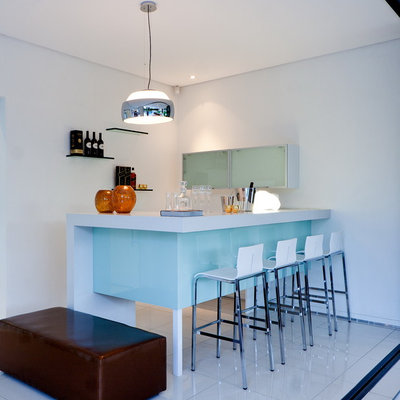 Example of a small trendy l-shaped white floor seated home bar design in Other with white countertops