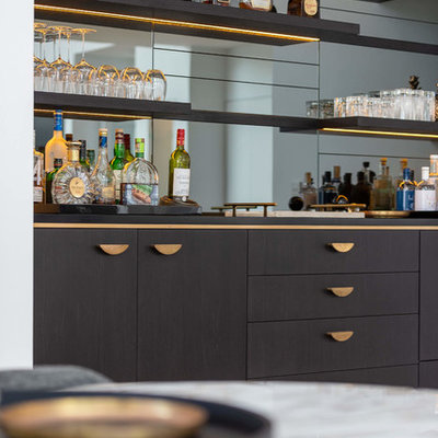 Large trendy single-wall light wood floor wet bar photo in Sydney with an integrated sink, flat-panel cabinets, black cabinets, solid surface countertops, mirror backsplash and black countertops