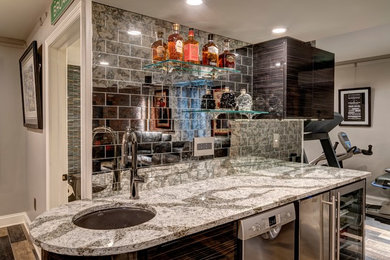 Photo of a small urban single-wall wet bar in Other with a built-in sink, flat-panel cabinets, mirror splashback and engineered stone countertops.
