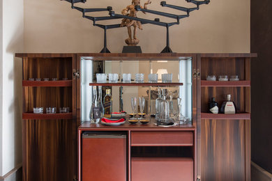Design ideas for a contemporary wet bar in London with flat-panel cabinets and brown cabinets.