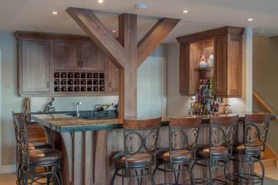 Mid-sized transitional l-shaped light wood floor and beige floor seated home bar photo in Other with shaker cabinets, medium tone wood cabinets and granite countertops