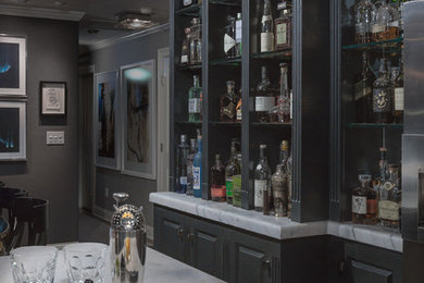 Inspiration for a mid-sized contemporary wet bar remodel in New York with raised-panel cabinets, gray cabinets and marble countertops