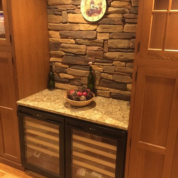 Kitchen with stone and wine fridges