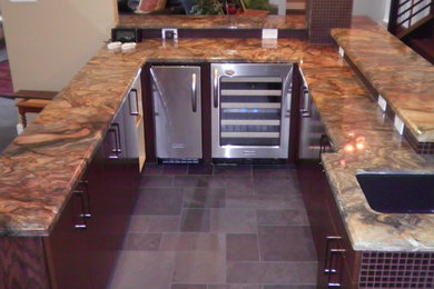 This is an example of a medium sized classic u-shaped breakfast bar in Houston with a submerged sink, flat-panel cabinets, dark wood cabinets, brown splashback and grey floors.