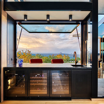 Example of a mid-sized trendy medium tone wood floor seated home bar design in Brisbane with open cabinets and an undermount sink