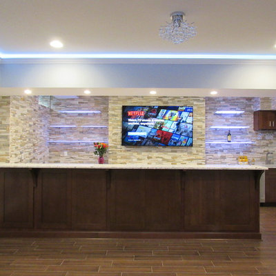 Example of a large trendy galley porcelain tile wet bar design in New York with an undermount sink, shaker cabinets, dark wood cabinets, granite countertops, multicolored backsplash and stone tile backsplash