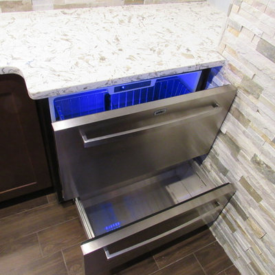 Large trendy galley porcelain tile wet bar photo in New York with an undermount sink, shaker cabinets, dark wood cabinets, granite countertops, multicolored backsplash and stone tile backsplash