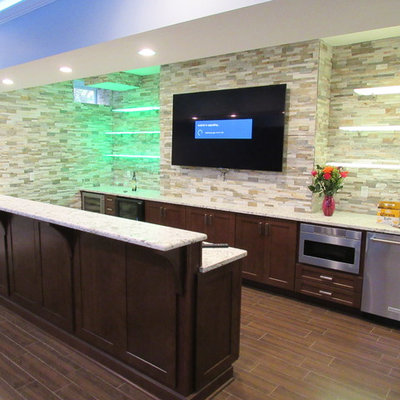 Large trendy galley porcelain tile wet bar photo in New York with shaker cabinets, dark wood cabinets, granite countertops, multicolored backsplash, stone tile backsplash and an undermount sink