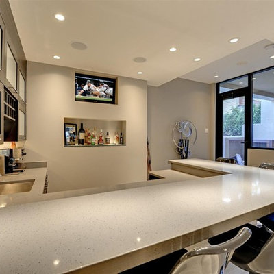 Inspiration for a large contemporary u-shaped home bar remodel in Minneapolis with an undermount sink, glass-front cabinets, gray cabinets and beige countertops