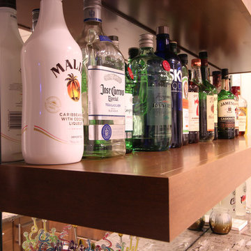 Mirror Backsplash with Alcohol Bottles on Floating Shelves