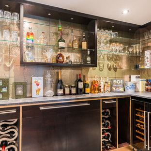 Inspiration for a small contemporary l-shaped home bar in London with flat-panel cabinets, grey floors, grey worktops, brown cabinets and beige splashback.