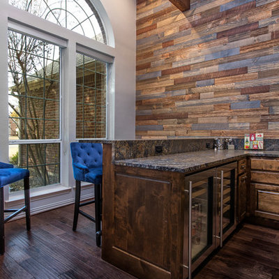 Mid-sized mountain style u-shaped dark wood floor and brown floor seated home bar photo in Dallas with raised-panel cabinets, dark wood cabinets, granite countertops and black countertops