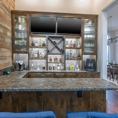 Seated home bar - mid-sized rustic u-shaped dark wood floor and brown floor seated home bar idea in Dallas with raised-panel cabinets, dark wood cabinets, granite countertops and black countertops