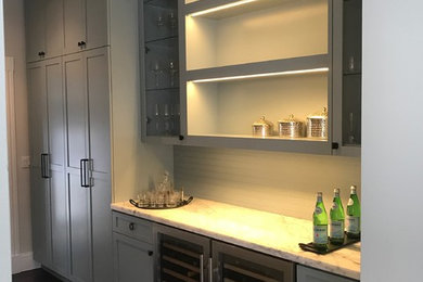 Medium sized contemporary single-wall wet bar in San Francisco with no sink, shaker cabinets, grey cabinets, marble worktops, dark hardwood flooring and brown floors.