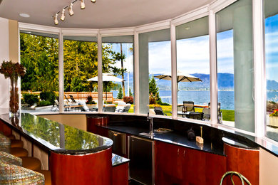 Inspiration for a large contemporary galley seated home bar remodel in Seattle with flat-panel cabinets, medium tone wood cabinets and granite countertops