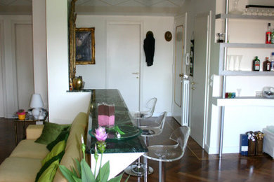 ヴェネツィアにある中くらいなコンテンポラリースタイルのおしゃれな着席型バー (I型、大理石カウンター、濃色無垢フローリング、茶色い床、緑のキッチンカウンター) の写真