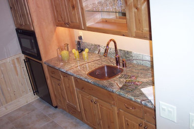 Example of a home bar design in Other with marble countertops