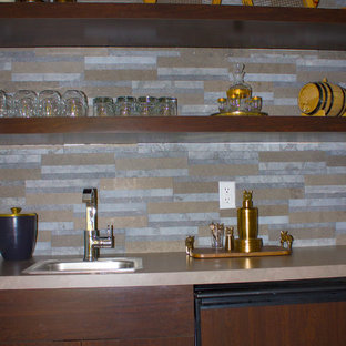 Inspiration for a small contemporary single-wall limestone floor wet bar remodel in Detroit with a drop-in sink, flat-panel cabinets, dark wood cabinets, granite countertops, multicolored backsplash and stone tile backsplash
