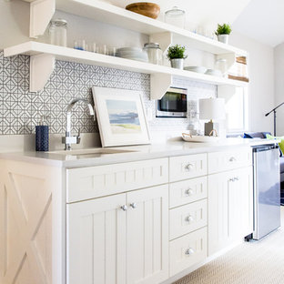 Example of a mid-sized cottage single-wall carpeted wet bar design in Salt Lake City with an undermount sink, white cabinets, quartz countertops, multicolored backsplash, ceramic backsplash and recessed-panel cabinets