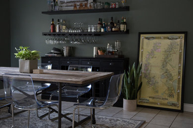 Home bar - large eclectic single-wall home bar idea in New Orleans with black cabinets