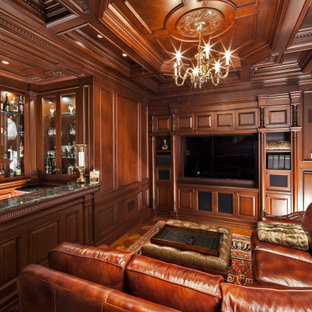 Immagine di un grande bancone bar chic con lavello sottopiano, ante di vetro, ante in legno scuro, top in granito, pavimento in laminato, pavimento giallo e top grigio