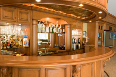 Seated home bar - large traditional u-shaped carpeted and beige floor seated home bar idea in Other with an undermount sink, recessed-panel cabinets, medium tone wood cabinets, wood countertops, mirror backsplash and brown countertops