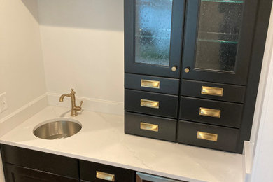 Mid-sized transitional galley dark wood floor wet bar photo in DC Metro with an undermount sink, shaker cabinets, black cabinets, quartz countertops and multicolored countertops