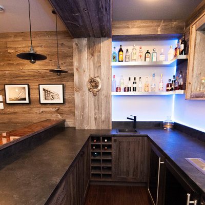 Inspiration for a large rustic u-shaped dark wood floor and brown floor seated home bar remodel in Other with a drop-in sink, shaker cabinets, light wood cabinets, concrete countertops, blue backsplash and glass sheet backsplash