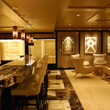 Second level bar overlooking entry, art accents, pendants, lamps, and recessed