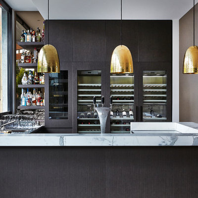 Example of a trendy u-shaped dark wood floor home bar design in Melbourne with flat-panel cabinets, dark wood cabinets and marble countertops
