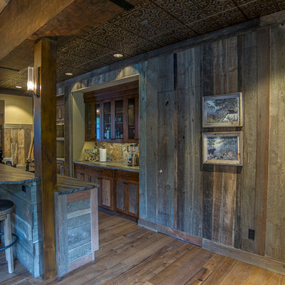 Inspiration for a rustic single-wall seated home bar remodel in Seattle with dark wood cabinets
