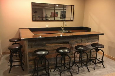 Example of a mid-sized mountain style single-wall concrete floor and gray floor seated home bar design in Denver with an undermount sink