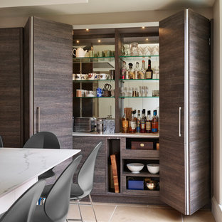 Design ideas for a small contemporary single-wall home bar in Berkshire with no sink, flat-panel cabinets, dark wood cabinets, mirror splashback, beige floors and white worktops.