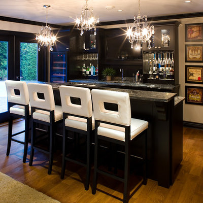 Inspiration for a transitional galley medium tone wood floor seated home bar remodel in Vancouver with black cabinets