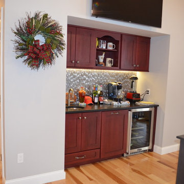 Transitional New Constrn. Home Bar w/ Red Stain cabinets & metallic backsplash
