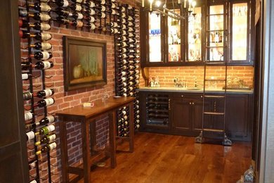 Example of a mid-sized classic single-wall medium tone wood floor wet bar design in Philadelphia with an undermount sink, medium tone wood cabinets, zinc countertops and red backsplash