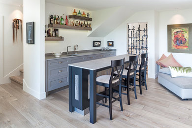 Example of a large transitional galley light wood floor and beige floor seated home bar design in Calgary with an undermount sink, quartzite countertops and open cabinets