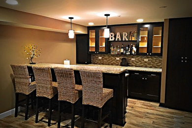 Seated home bar - mid-sized traditional u-shaped porcelain tile seated home bar idea in Chicago with an undermount sink, raised-panel cabinets, dark wood cabinets, granite countertops, brown backsplash and glass tile backsplash