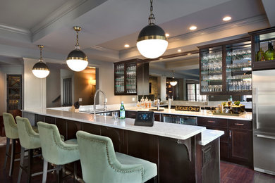 Example of a large classic u-shaped dark wood floor and brown floor seated home bar design in New York with glass-front cabinets, dark wood cabinets and marble countertops