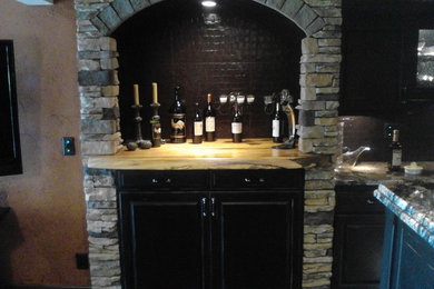 Inspiration for a small mediterranean home bar remodel in Kansas City