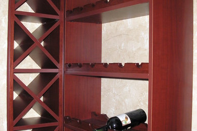 Home bar - traditional l-shaped home bar idea in Houston with flat-panel cabinets