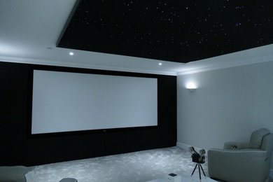 This is an example of a contemporary home cinema in Surrey.