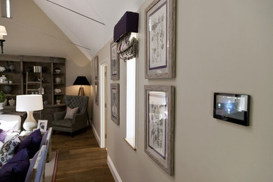 Inspiration for a large open plan home cinema in Surrey with beige walls, dark hardwood flooring and a wall mounted tv.